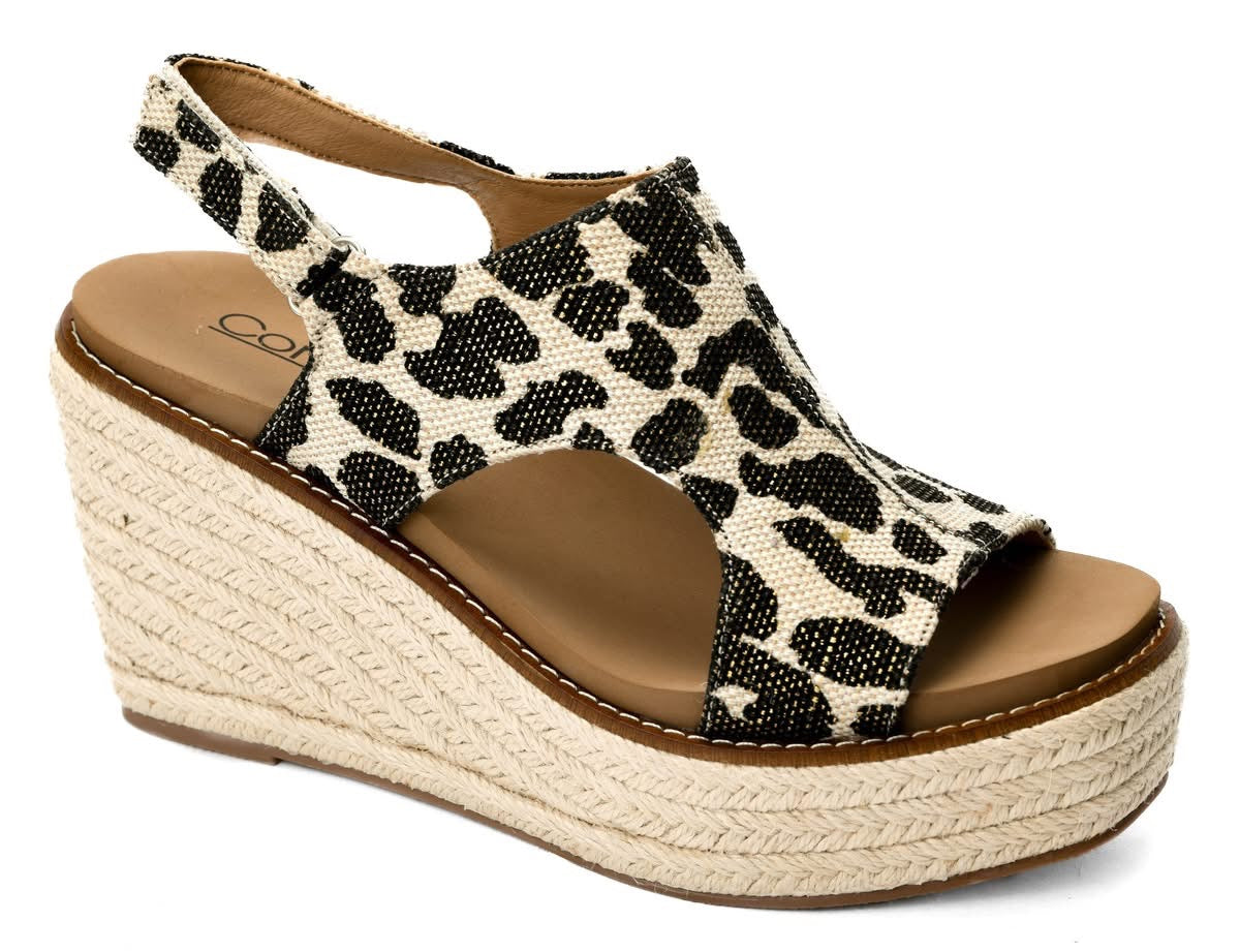 Wedge sandal with leopard print strap on a white background