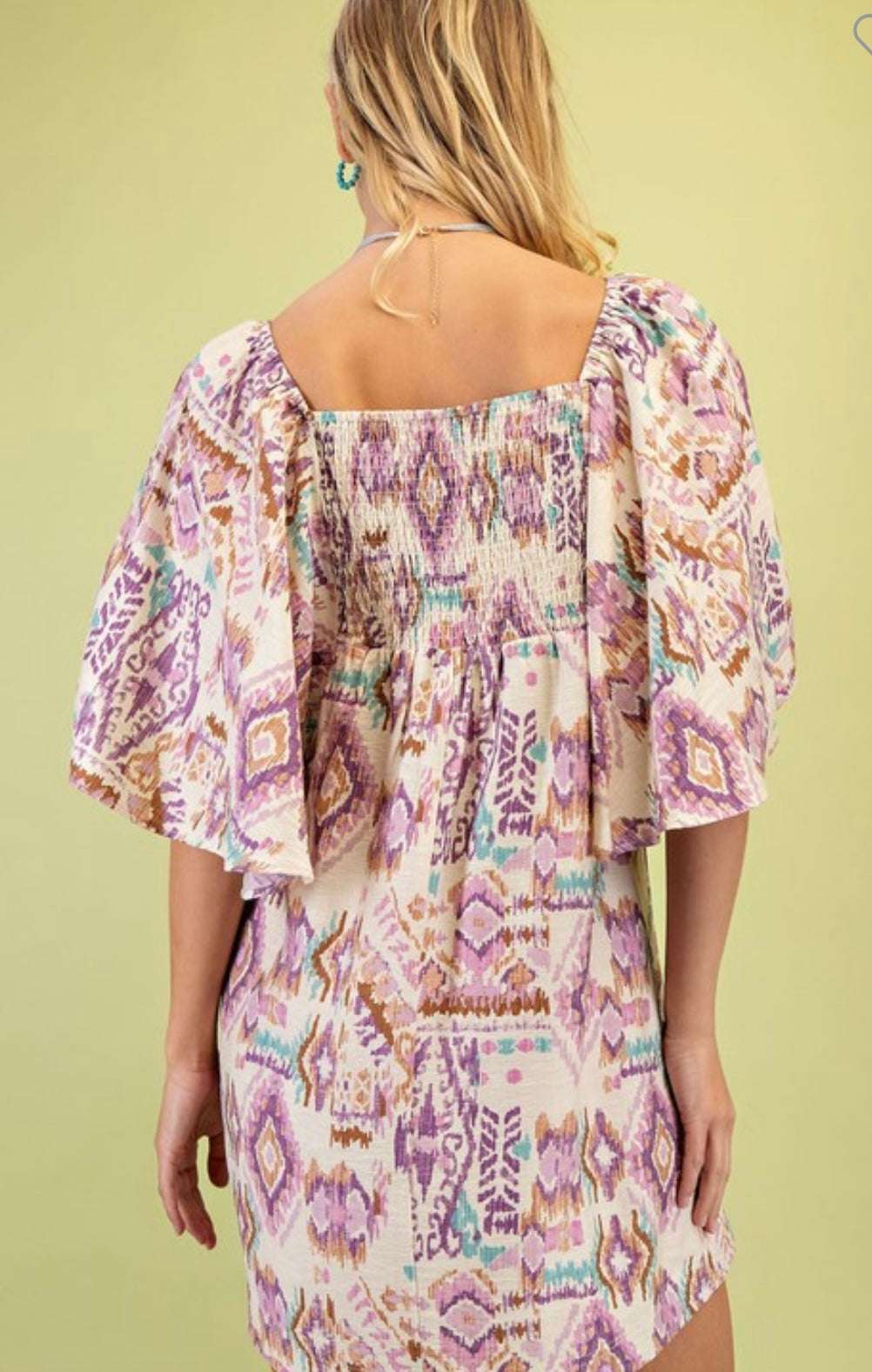 Woman wearing a fall color patterned dress