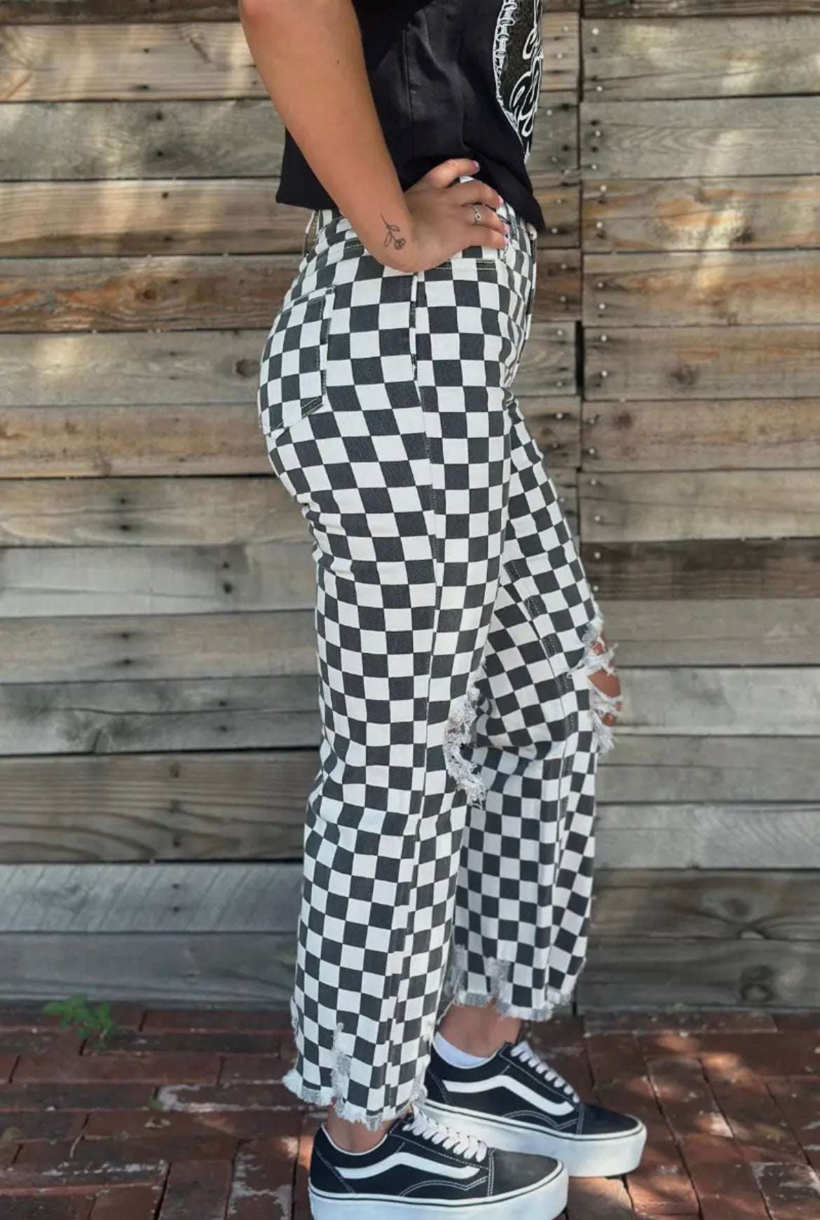 Sterling Kreek Round The Track Jeans with faded black and white checkered pattern and distressed knees for a bold, fashion-forward look, side view