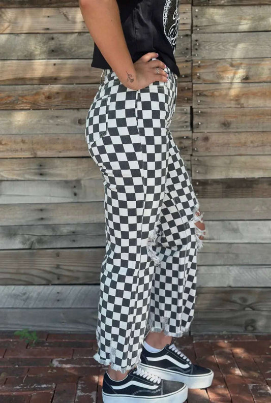 Sterling Kreek Round The Track Jeans with faded black and white checkered pattern and distressed knees for a bold, fashion-forward look, side view