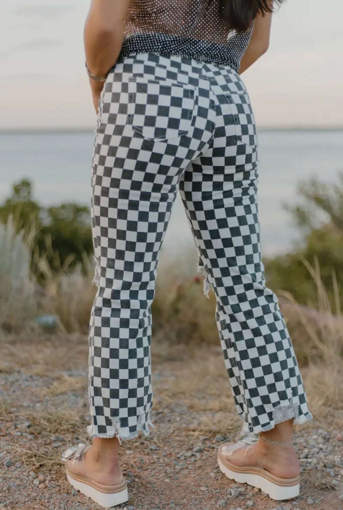 Sterling Kreek Round The Track Jeans with faded black and white checkered pattern and distressed knees for a bold, fashion-forward look, back view