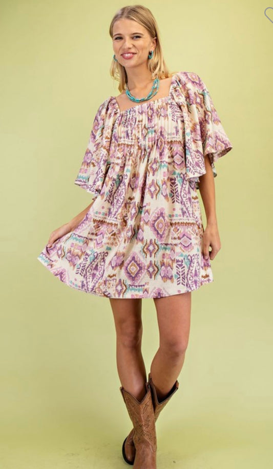 Woman wearing a fall western patterned dress with ruffled sleeves