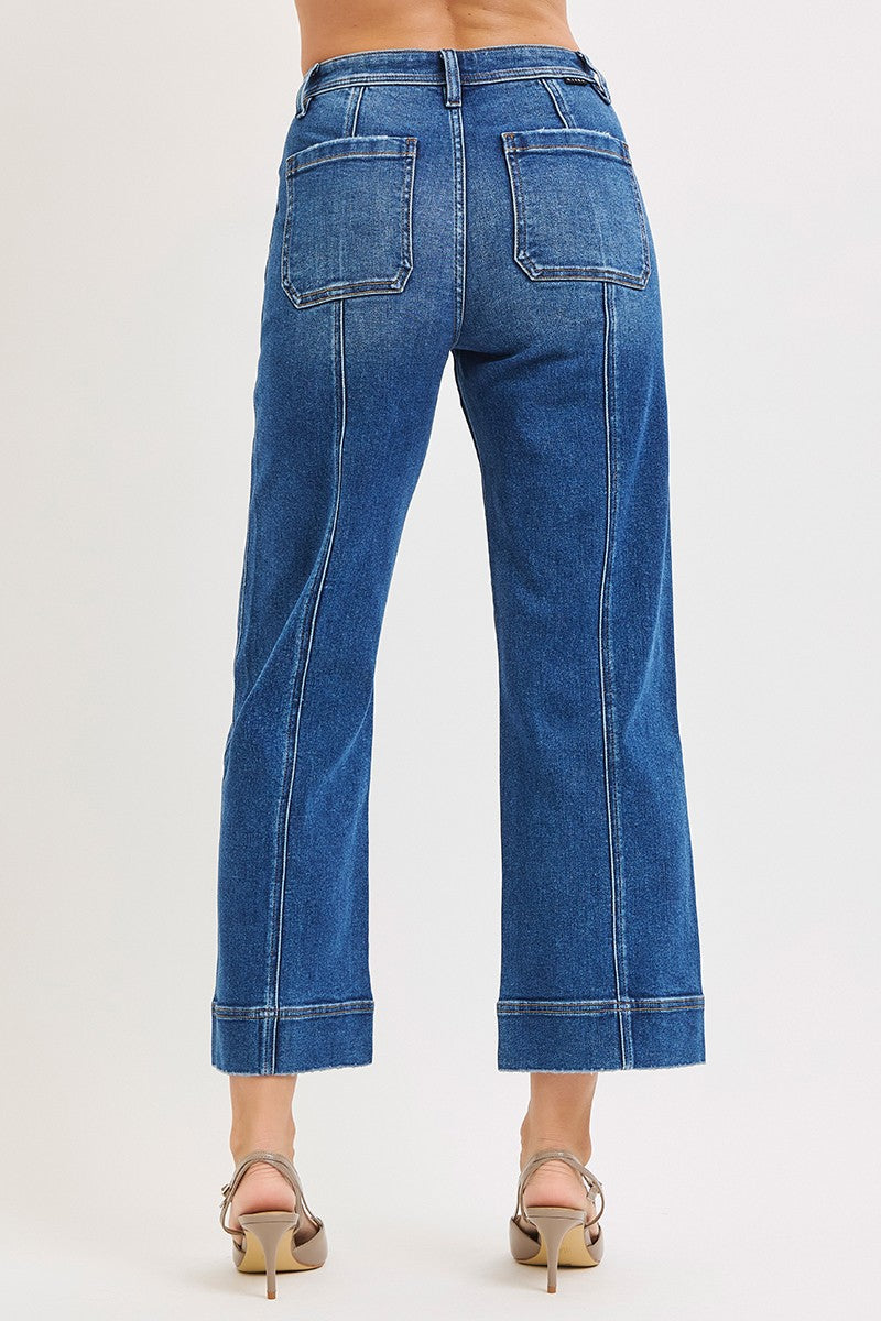Blue jeans worn by a person on a white background