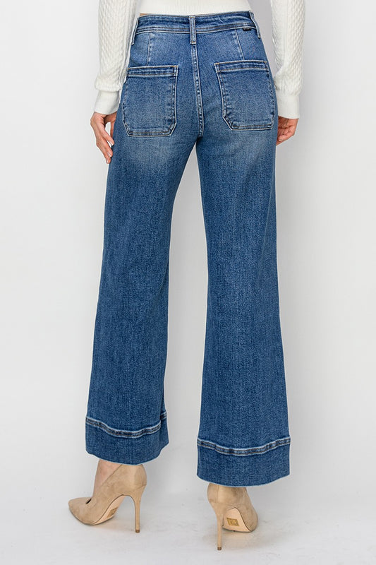 Blue jeans worn by a person on a white background
