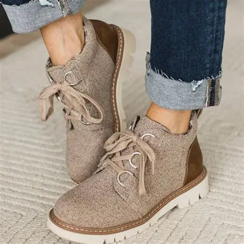 Neutral lace-up bootie with textured knit upper, plaid flannel lining, contrast suede heel patch, and chunky white lug sole by Corky's Footwear