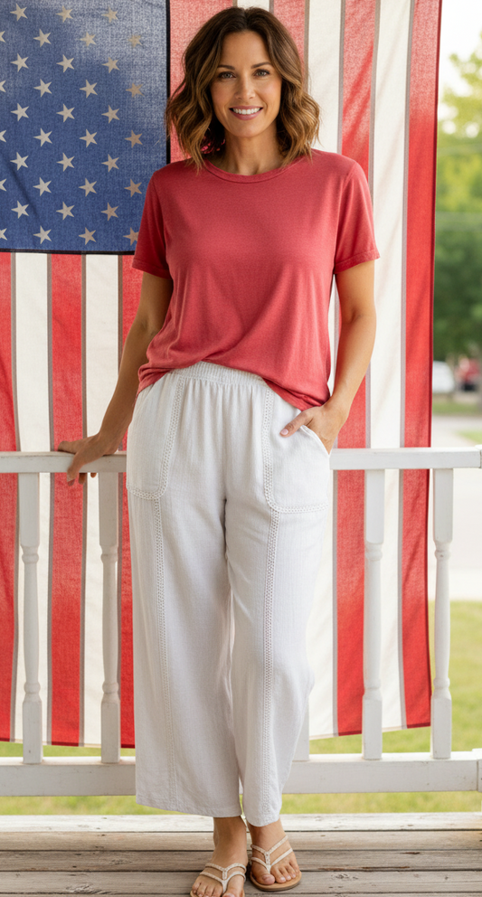 Person wearing white wide-leg pants on a plain background