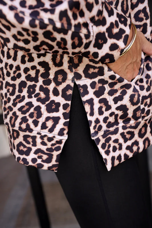 Woman wearing a leopard print pullover side view