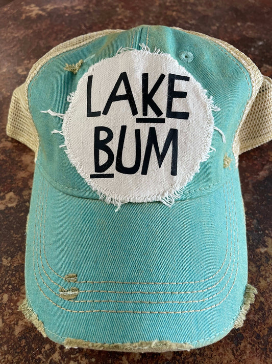 Blue cap with 'Lake Bum' patch on a textured surface