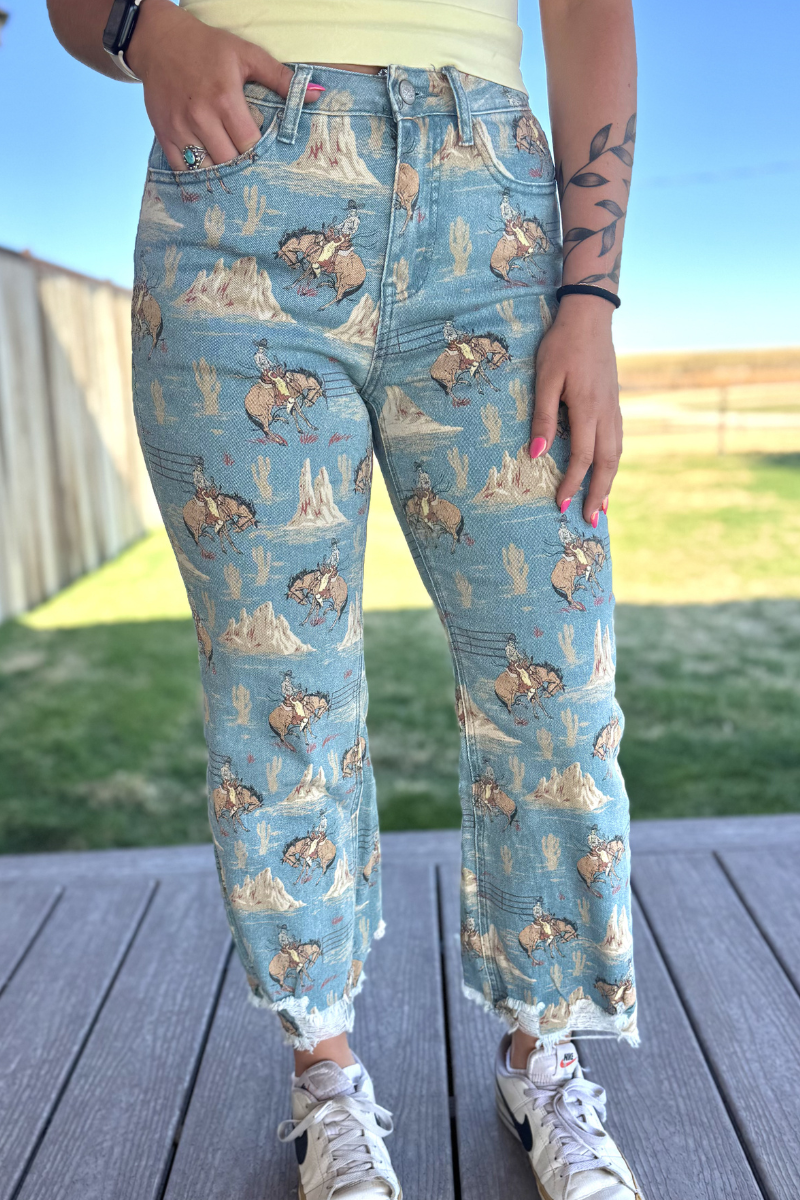 Person wearing blue jeans with bear and nature pattern outdoors