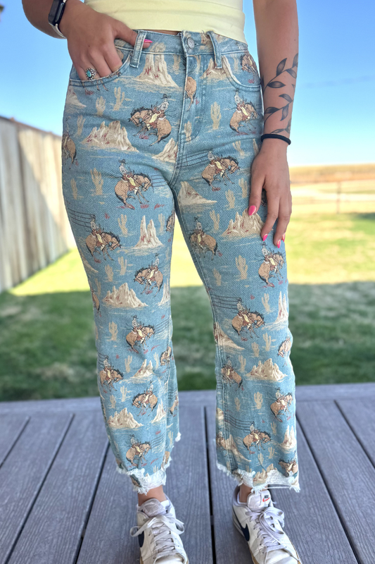 Person wearing blue jeans with bear and nature pattern outdoors