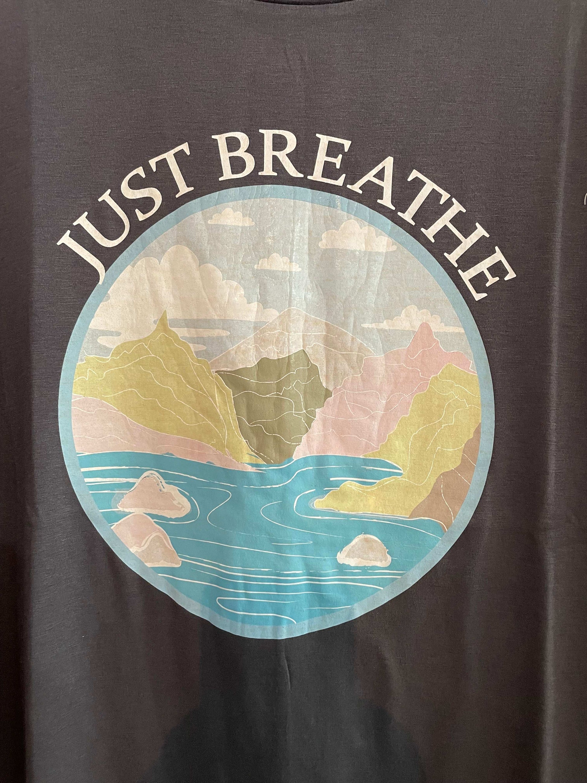 Charcoal t-shirt with 'Just Breathe' graphic design featuring a colorful abstract pattern.