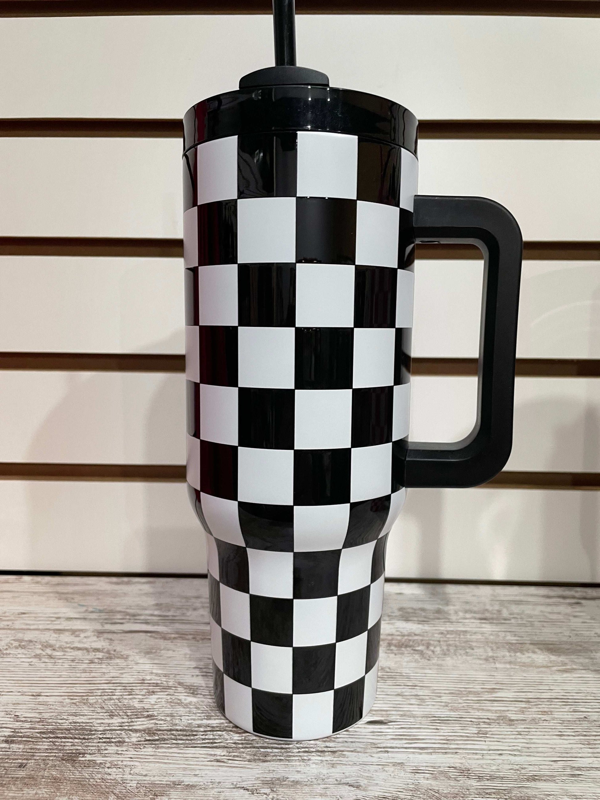 Black and white checkered tumbler with insulated design for keeping drinks cool in style