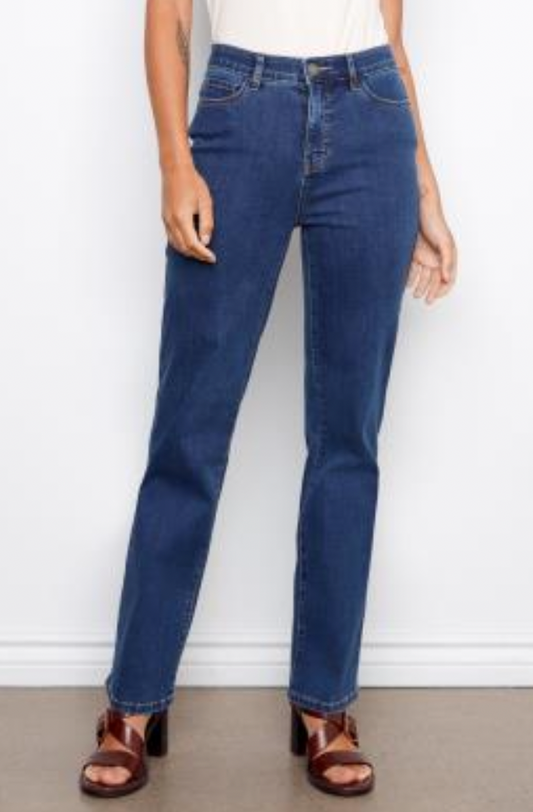 Woman wearing a white tank top and blue jeans against a white background