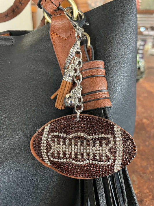 Sparkly football-shaped purse charm and key chain with metallic accents, perfect for game day style