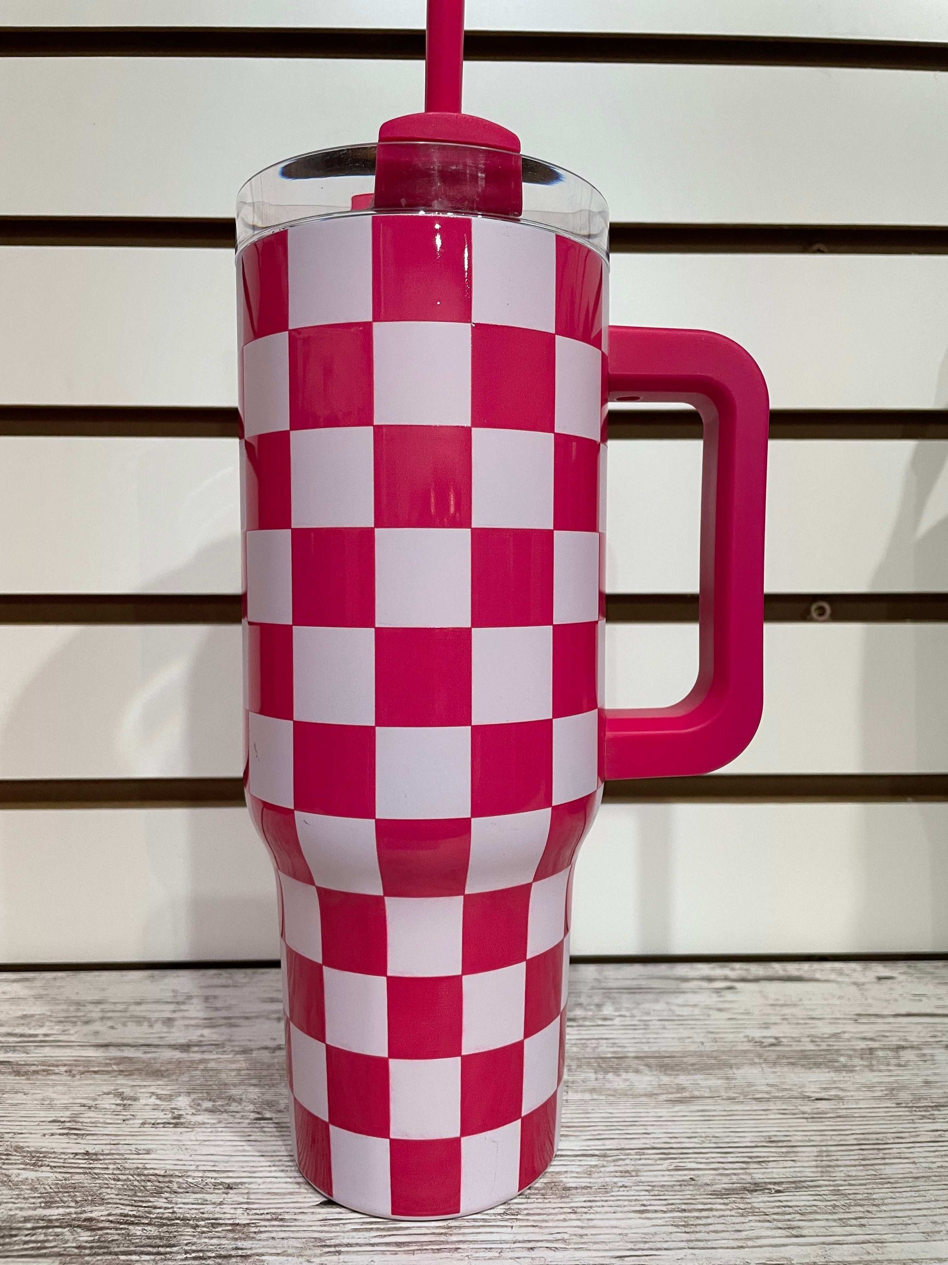 Pink and white checkered tumbler with insulated design for keeping drinks cool in style