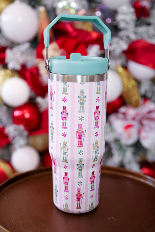 Tumbler with nutcracker design on a festive background