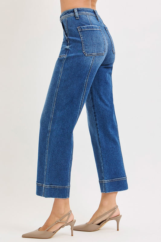 Blue jeans worn by a person on a white background